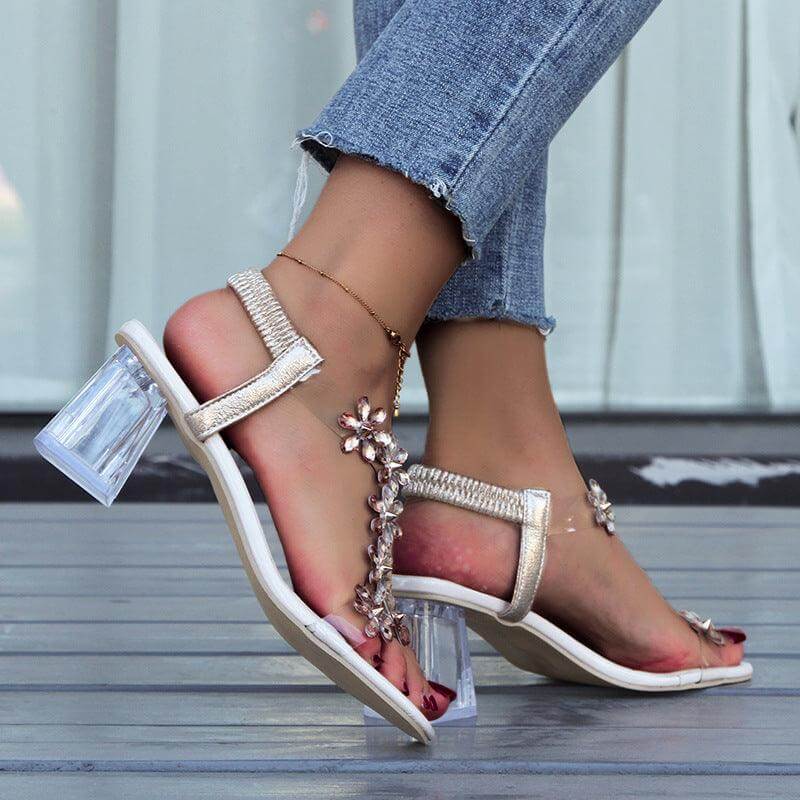 Stylish fashion flower sandals with transparent square heel, showcasing unique design and comfort, worn with ankle jeans.